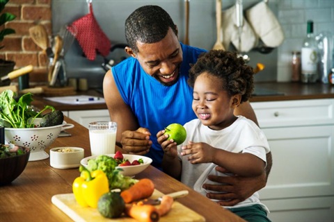 african american dad and son in kitchen