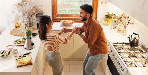 woman and man dancing in the kitchen