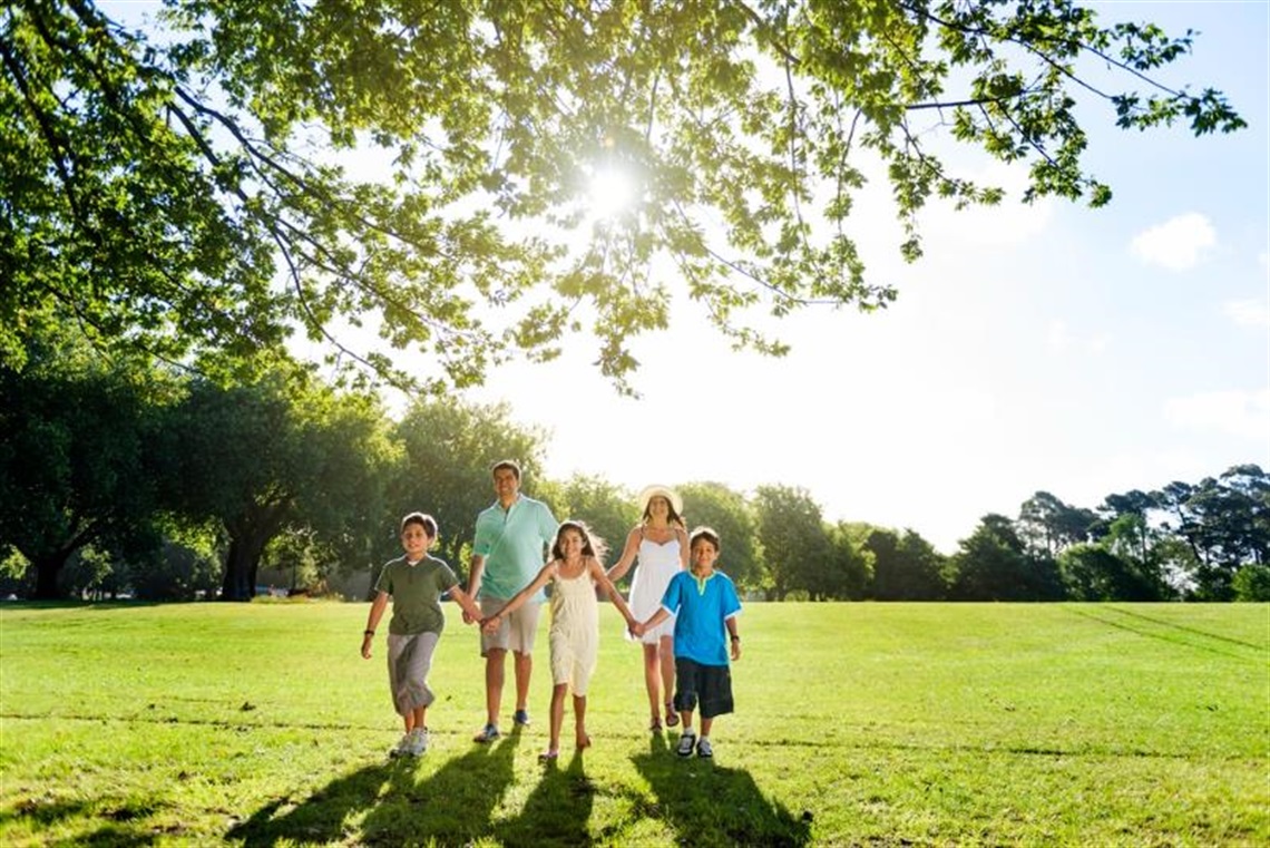 Family of five walking together outdoors