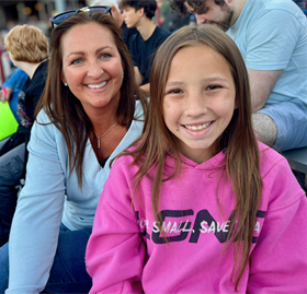 adult female and girl smiling