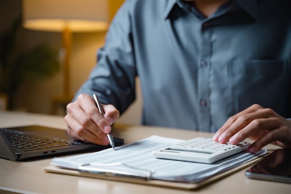 Man completing accounting paperwork
