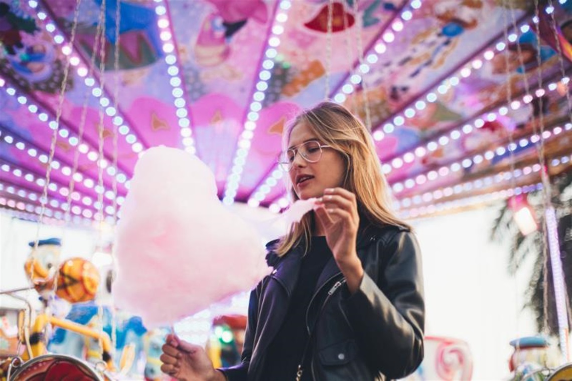 Woman eating cotton candy