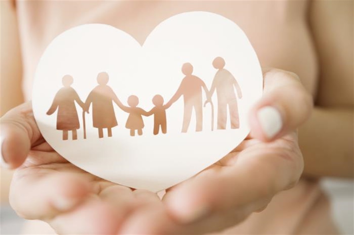 Hands holding a heart cutout